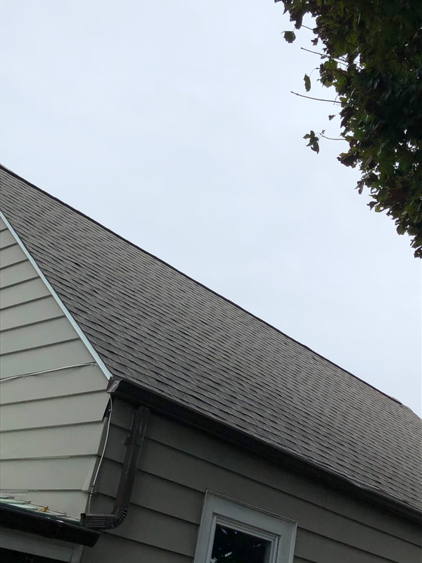 New gray asphalt roofing view from the ground