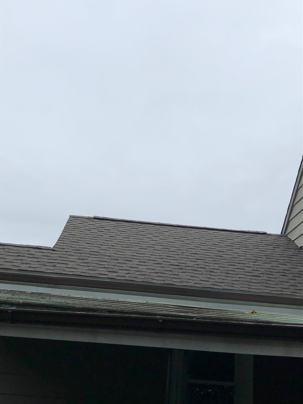 New gray asphalt roofing view from the ground