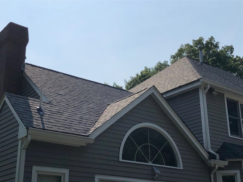 Roofing installation on brown house with white trim - gray asphalt shingles September 2021