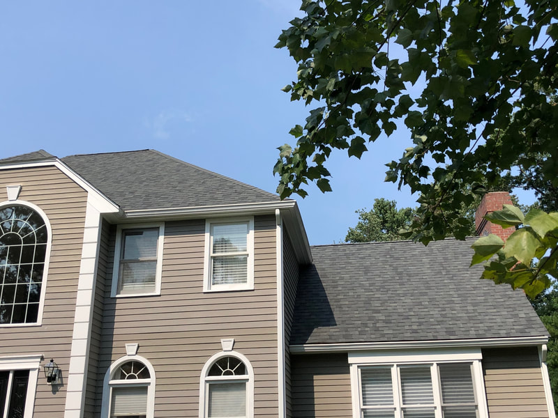 Roofing installation on brown house with white trim front of house view - gray asphalt shingles September 2021